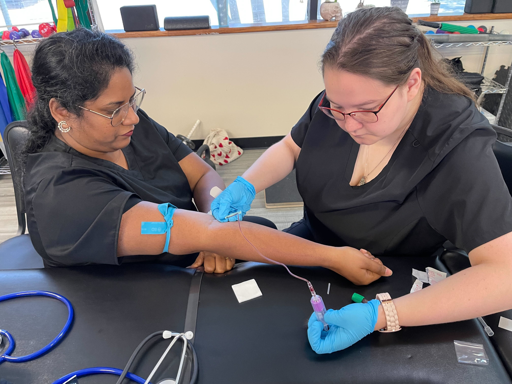 medical assistant student practicing phlebotomy during lesson